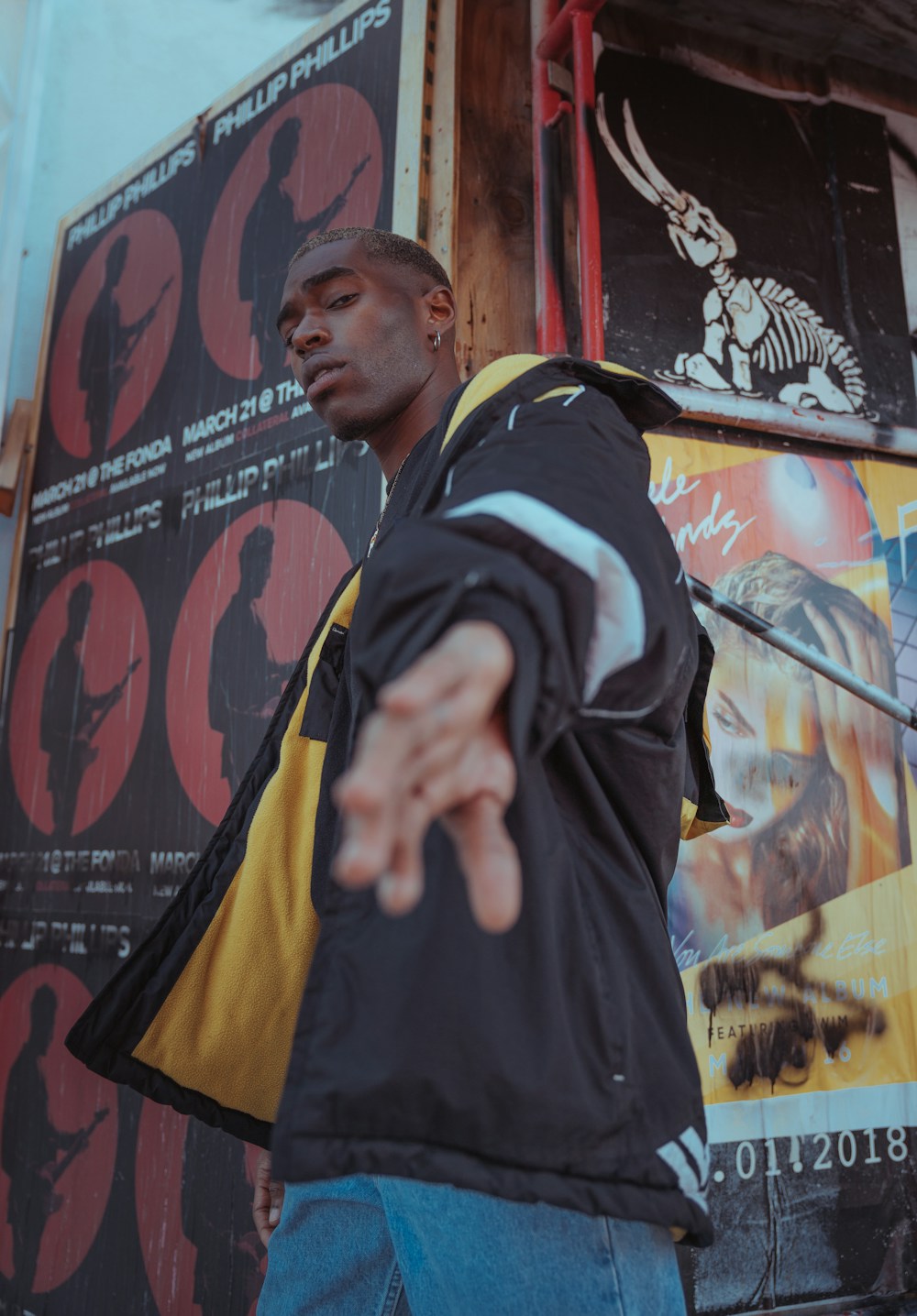 Model wearing a black and yellow streetwear jacket
